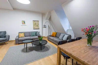 a living room with a couch and a table at Harrachovsky Palace in Prague