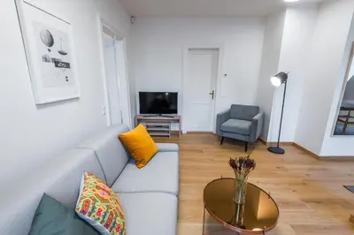 a living room with a couch and a table at Harrachovsky Palace in Prague