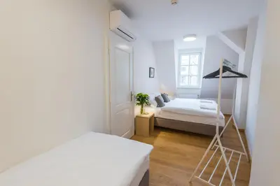 a bedroom with two beds and a ladder in it at Harrachovsky Palace in Prague