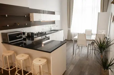 a kitchen with a counter and stools in a room at Luxury Modern Designed Oldtown Apartment in Prague