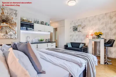 a wooden table with a keyboard and a air conditioner at AIR CONDITIONED Terrace Apartment Prague in Prague