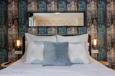 a bedroom with a bed with a mirror above it at AIR CONDITIONED Terrace Apartment Prague in Prague