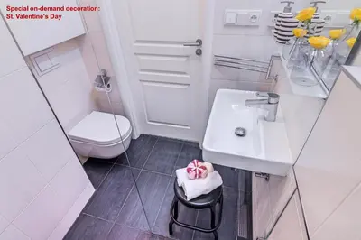 a white bathroom with a sink and a toilet at AIR CONDITIONED Terrace Apartment Prague in Prague