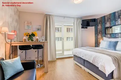 a living room with a couch and a table with chairs at AIR CONDITIONED Terrace Apartment Prague in Prague