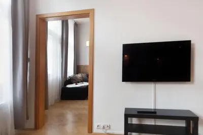 a living room with a flat screen tv on a wall at Old Town Melantrichova Apartment in Prague