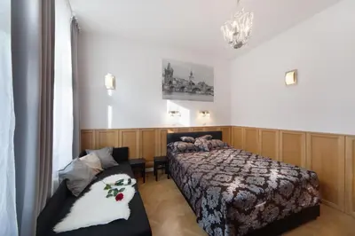 a bedroom with a bed and a couch at Old Town Melantrichova Apartment in Prague