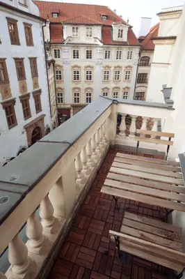 a balcony with a bench and a building at Old Town Melantrichova Apartment in Prague