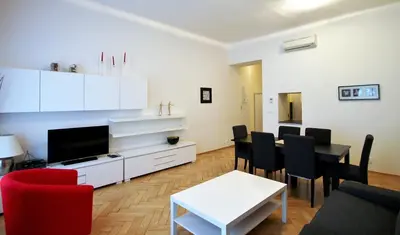 a living room with a table and a dining room at Residence Salvator - by Prague City Apartments in Prague