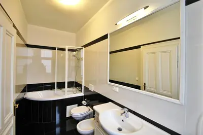 a bathroom with a sink and a toilet and a mirror at Residence Salvator - by Prague City Apartments in Prague