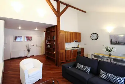 a living room with a couch and a kitchen at Residence Salvator - by Prague City Apartments in Prague