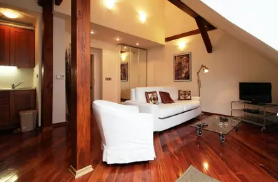 a living room with a white couch and a tv at Residence Salvator - by Prague City Apartments in Prague