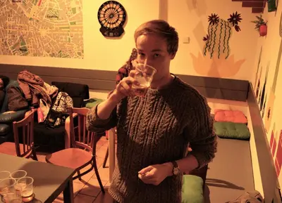 a woman is drinking a glass of wine at Travel&Joy backpackers in Prague