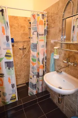 a bathroom with a sink and a shower curtain at Travel&Joy backpackers in Prague