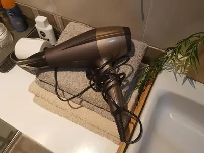 a blow dryer sitting on a counter next to a sink at Apartments With The Lions in Prague