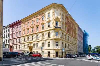 a large building on the corner of a street at Apartments With The Lions in Prague