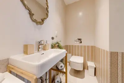 a bathroom with a sink and a toilet at Apartments With The Lions in Prague
