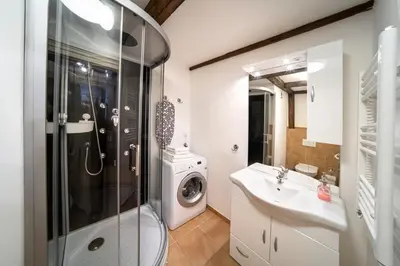 a kitchen with white cabinets and a table in a room at Old Town - Aparthotel Michalska in Prague