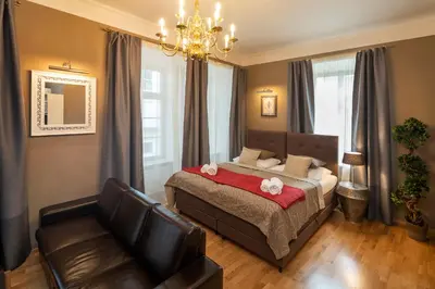 a bedroom with two beds and a red dresser at Old Town - Aparthotel Michalska in Prague