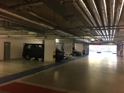 a parking garage with a van parked in it at Apartments in Residence Garden Towers in Prague