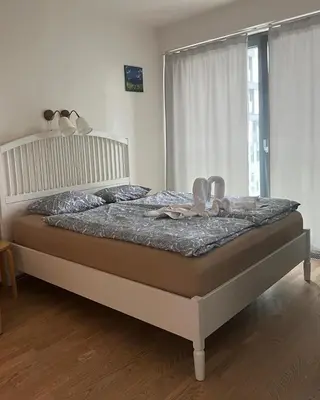 a bedroom with a bed in a room with a window at Apartments in Residence Garden Towers in Prague