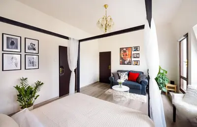 a bedroom with a bed and a couch at A/C + TERRACE Breakfast at Tiffany’s in Prague
