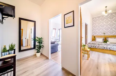 a living room with a bed and a mirror at A/C + TERRACE Breakfast at Tiffany’s in Prague
