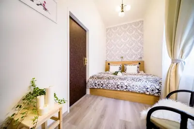 a small bedroom with a bed and a window at A/C + TERRACE Breakfast at Tiffany’s in Prague