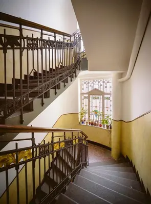 an empty staircase in a building with a window at A/C + TERRACE Breakfast at Tiffany’s in Prague