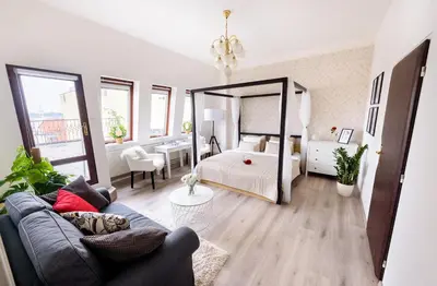 a living room with a bed and a couch at A/C + TERRACE Breakfast at Tiffany’s in Prague