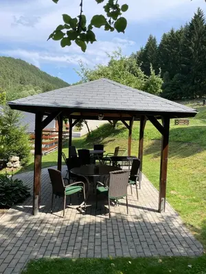 a gazebo with a table and chairs under it at Hájovna Bukovec in Bukovec