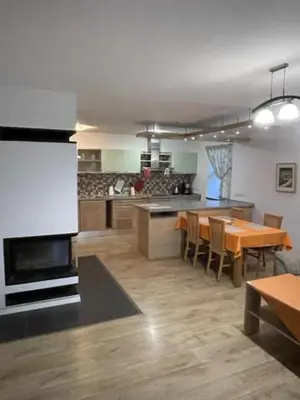 a kitchen with a table and a dining room at Hájovna Bukovec in Bukovec