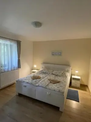 a bedroom with a bed with two candles on it at Hájovna Bukovec in Bukovec