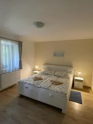 a bedroom with a bed and a window with two lights at Hájovna Bukovec in Bukovec