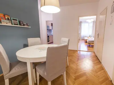 a dining room with a white table and chairs at Modern Central Apartment Dlouhá in Prague