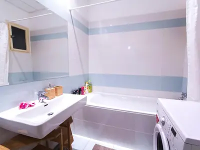 a bathroom with a sink and a bath tub at Modern Central Apartment Dlouhá in Prague