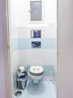 a small bathroom with a toilet and a window at Modern Central Apartment Dlouhá in Prague