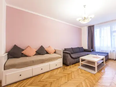 a living room with a couch and a table at Modern Central Apartment Dlouhá in Prague