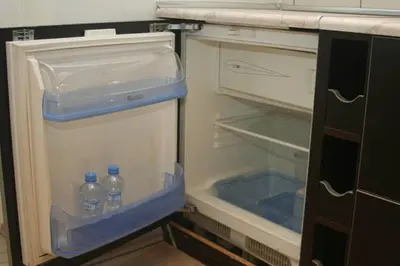 an empty refrigerator with two bottles of water in it at Apartment Argentinská 8 in Prague