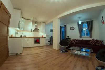 a living room with a couch and a kitchen at Prague Gate Apartments in Prague