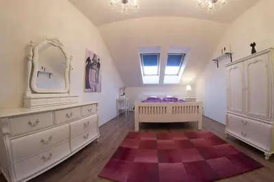 a bedroom with a bed and a dresser and a mirror at Prague Gate Apartments in Prague