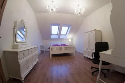 a bedroom with a bed and a vanity and a mirror at Prague Gate Apartments in Prague