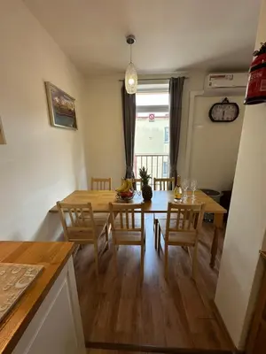 a kitchen and dining room with a table and chairs at Prague Gate Apartments in Prague