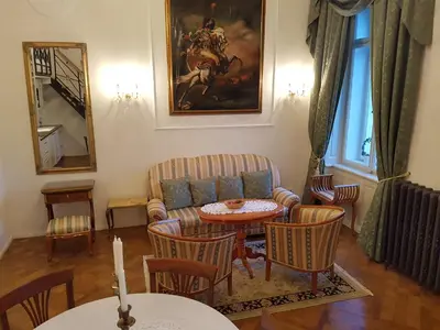 a living room with a couch and a table and chairs at Charles apartment in Prague