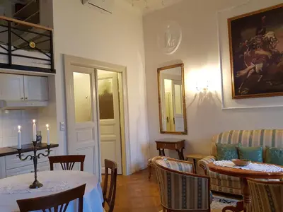 a dining room with two tables and chairs with candles on them at Charles apartment in Prague