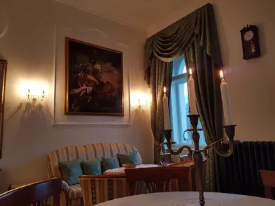 a dining room with a table and a window at Charles apartment in Prague