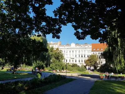 a large white building in the middle of a park at Charles apartment in Prague
