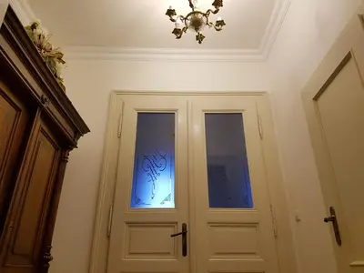 a door with a window and a chandelier at Charles apartment in Prague