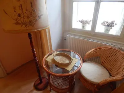 a room with a lamp and a table and chairs at Miraculous Appartement in Prague