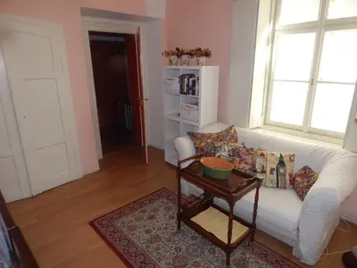 a living room with a white couch and a table at Miraculous Appartement in Prague