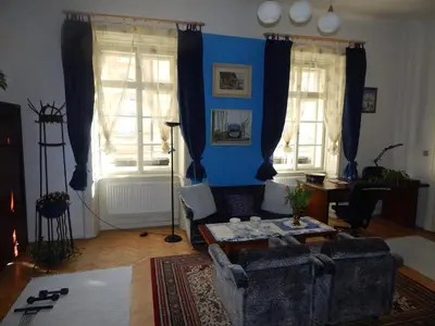 a living room with a couch and a table at Miraculous Appartement in Prague